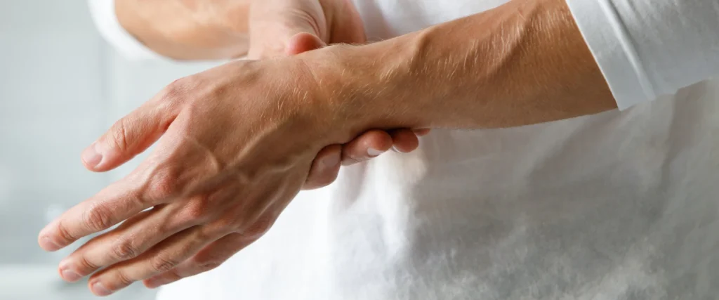 Person holding other hand in pain