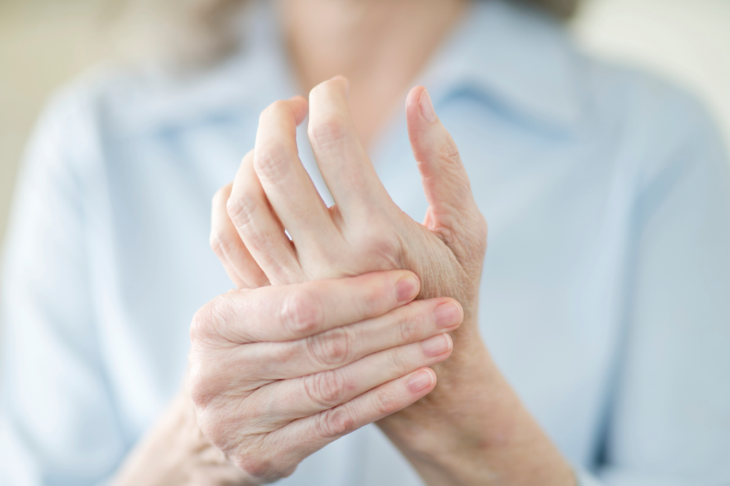 Person holding other hand that is in pain