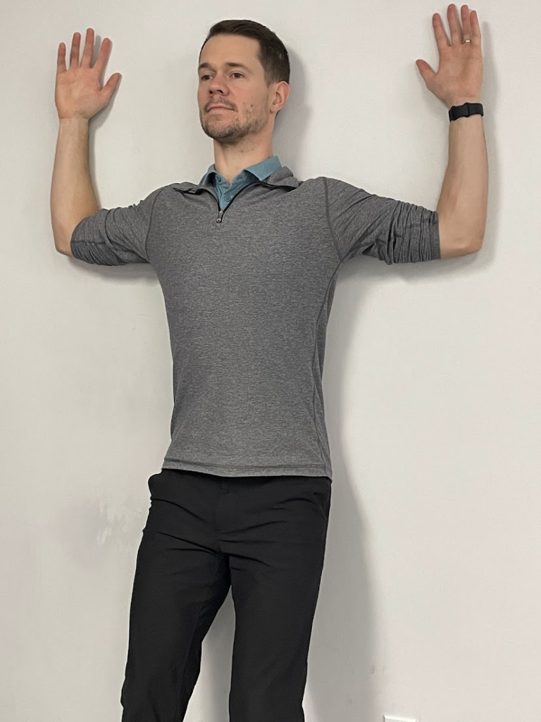 Upper back wall angel exercise demonstrated by Physiotherapist Coulton Roe