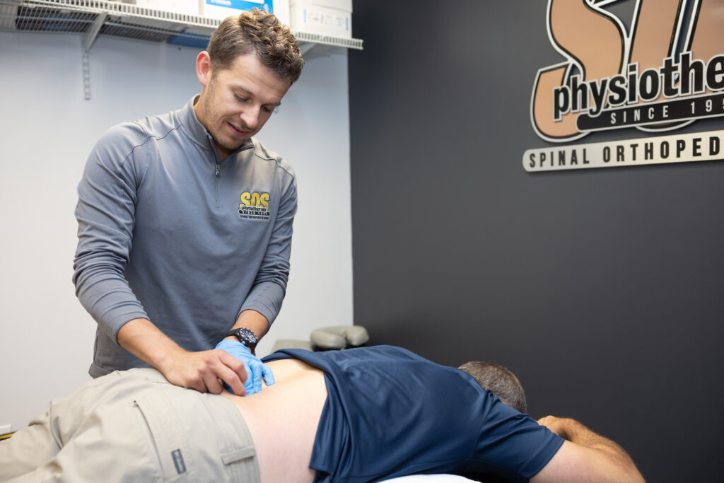 Physiotherapist helping patient
