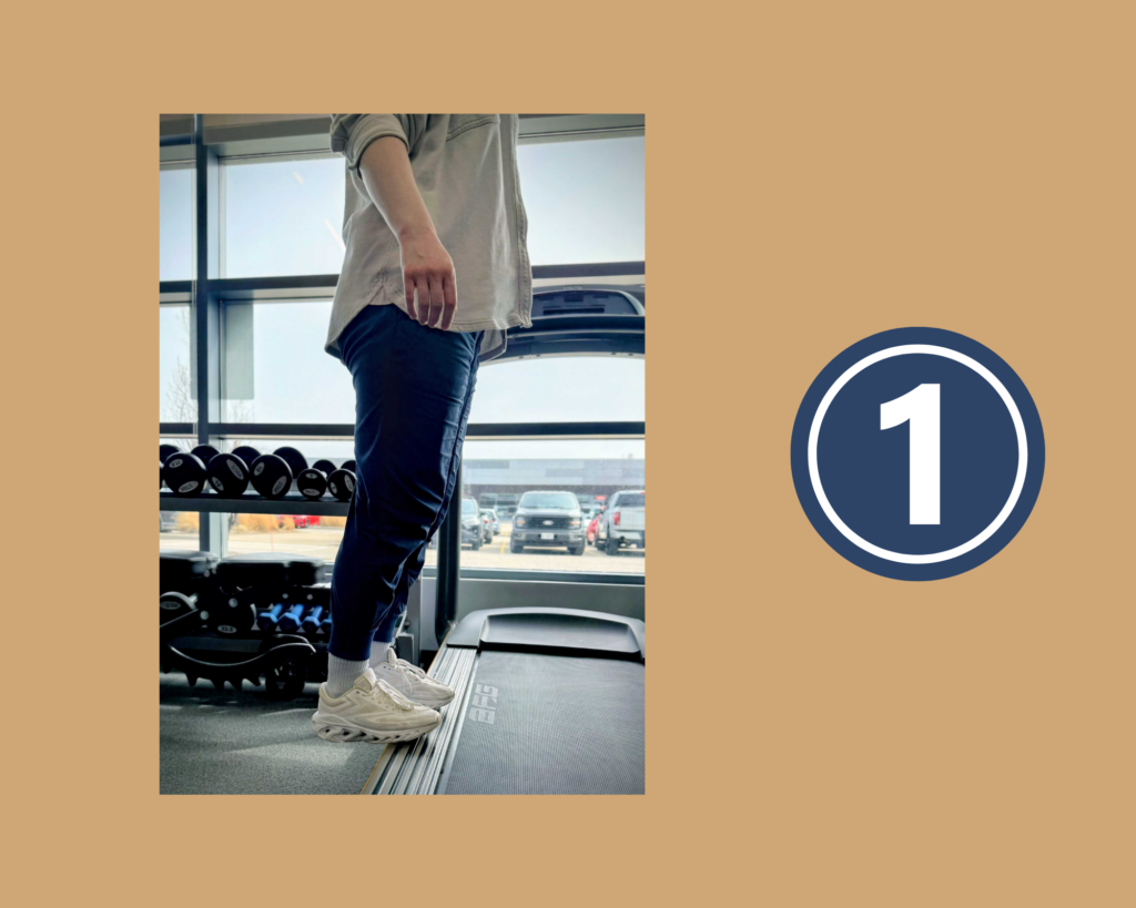 Phyisotherapist Ali Shaw demonstrating step 1 of the Stair Calf Exercise