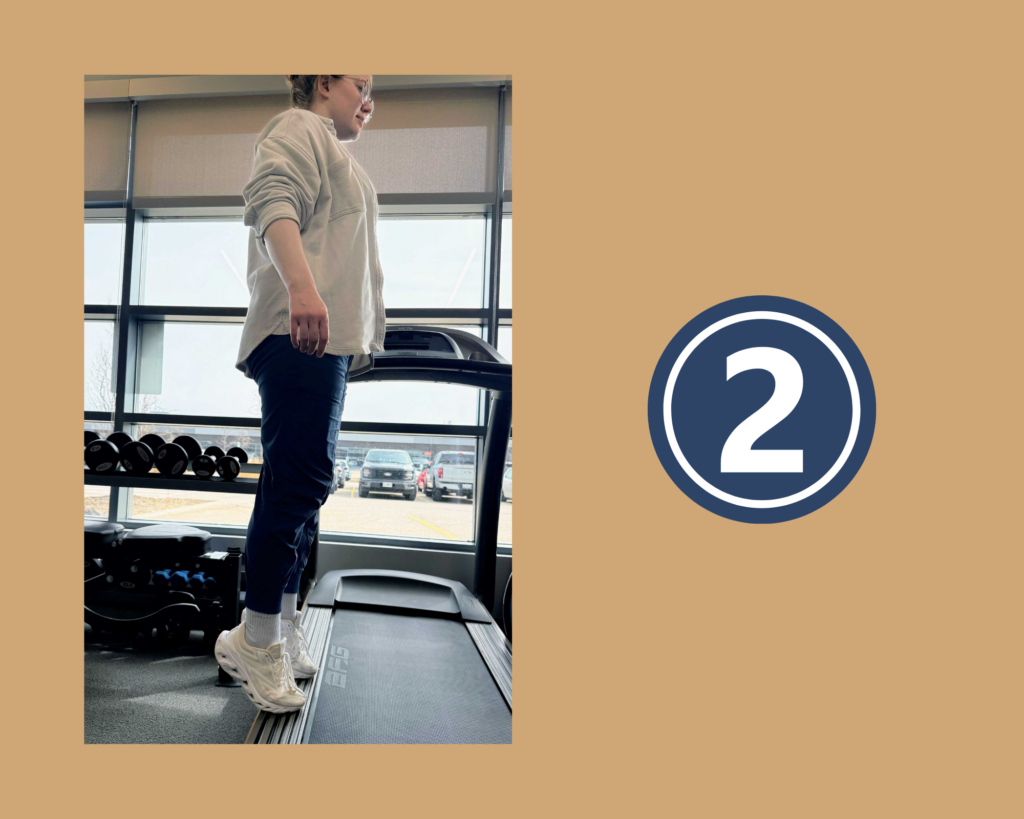 Phyisotherapist Ali Shaw demonstrating step 2 of the Stair Calf Exercise